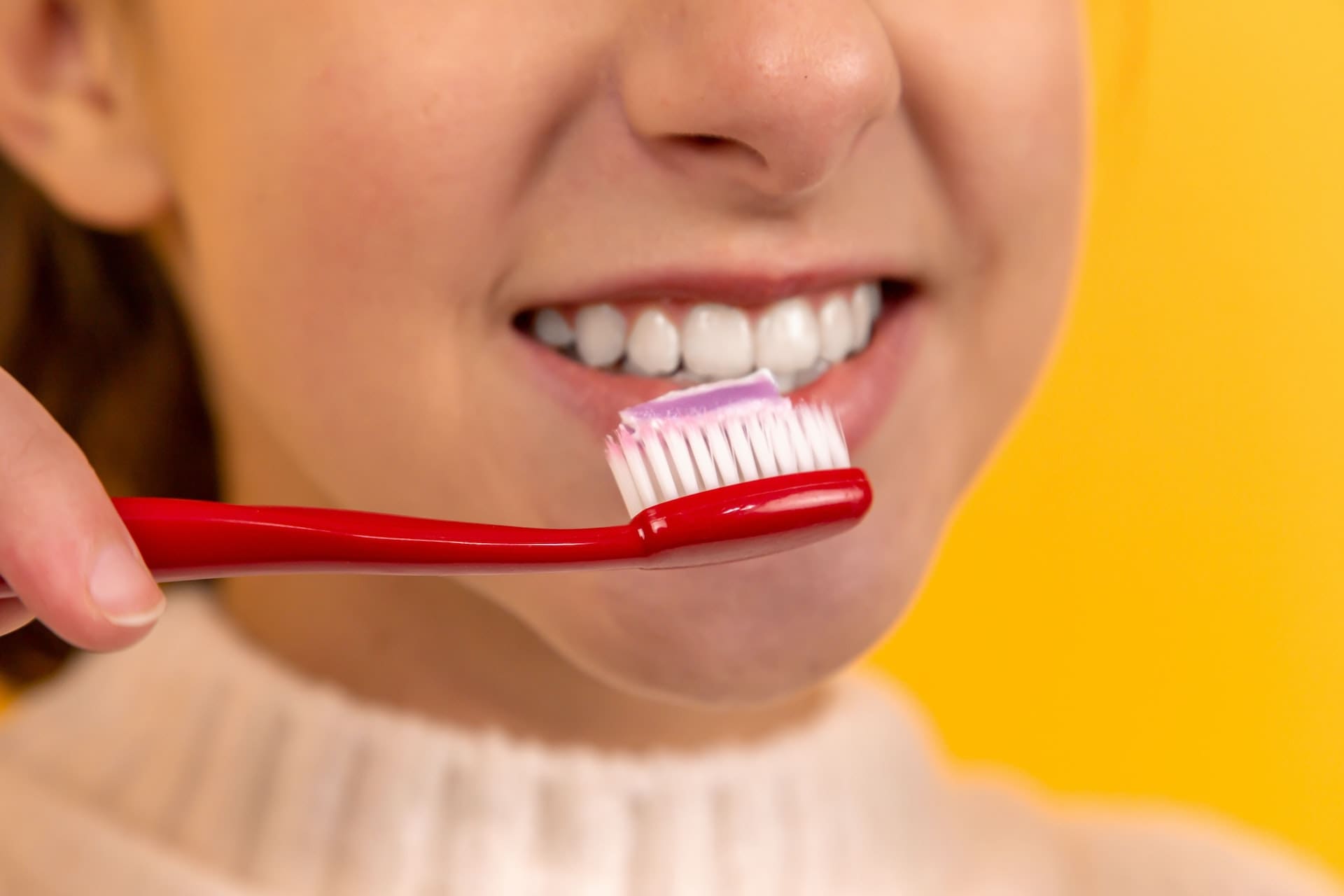 Close-up of a person brushing their teeth