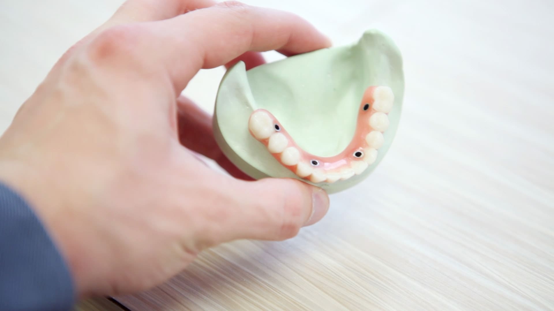Hand holding dental model