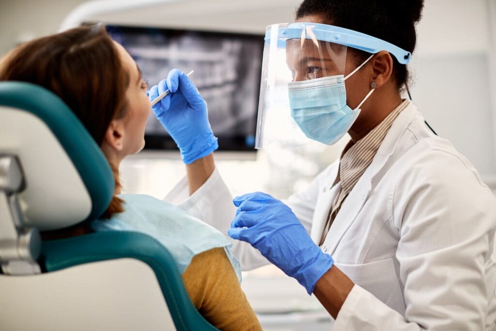 Patient undergoing periodontal scaling and root planing procedure