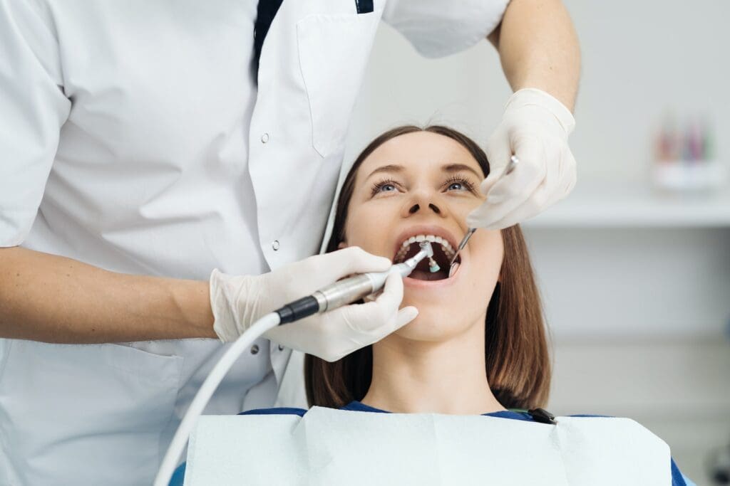 Female patient undergoing teeth whitening treatment.