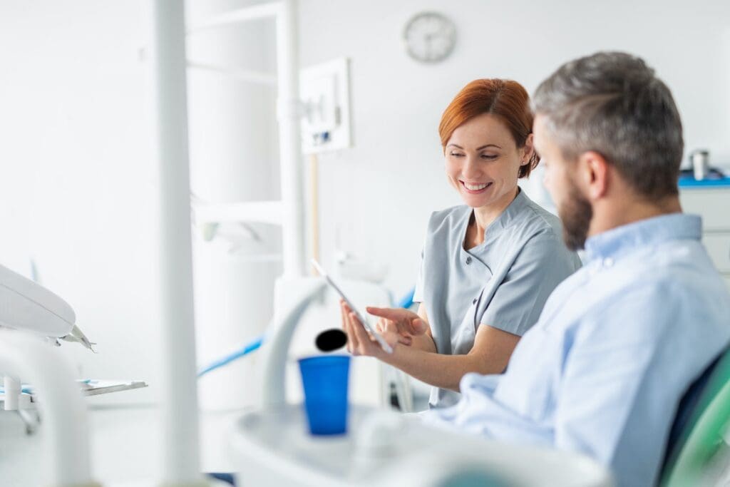 Dentist explaining implant-supported dentures to a patient.