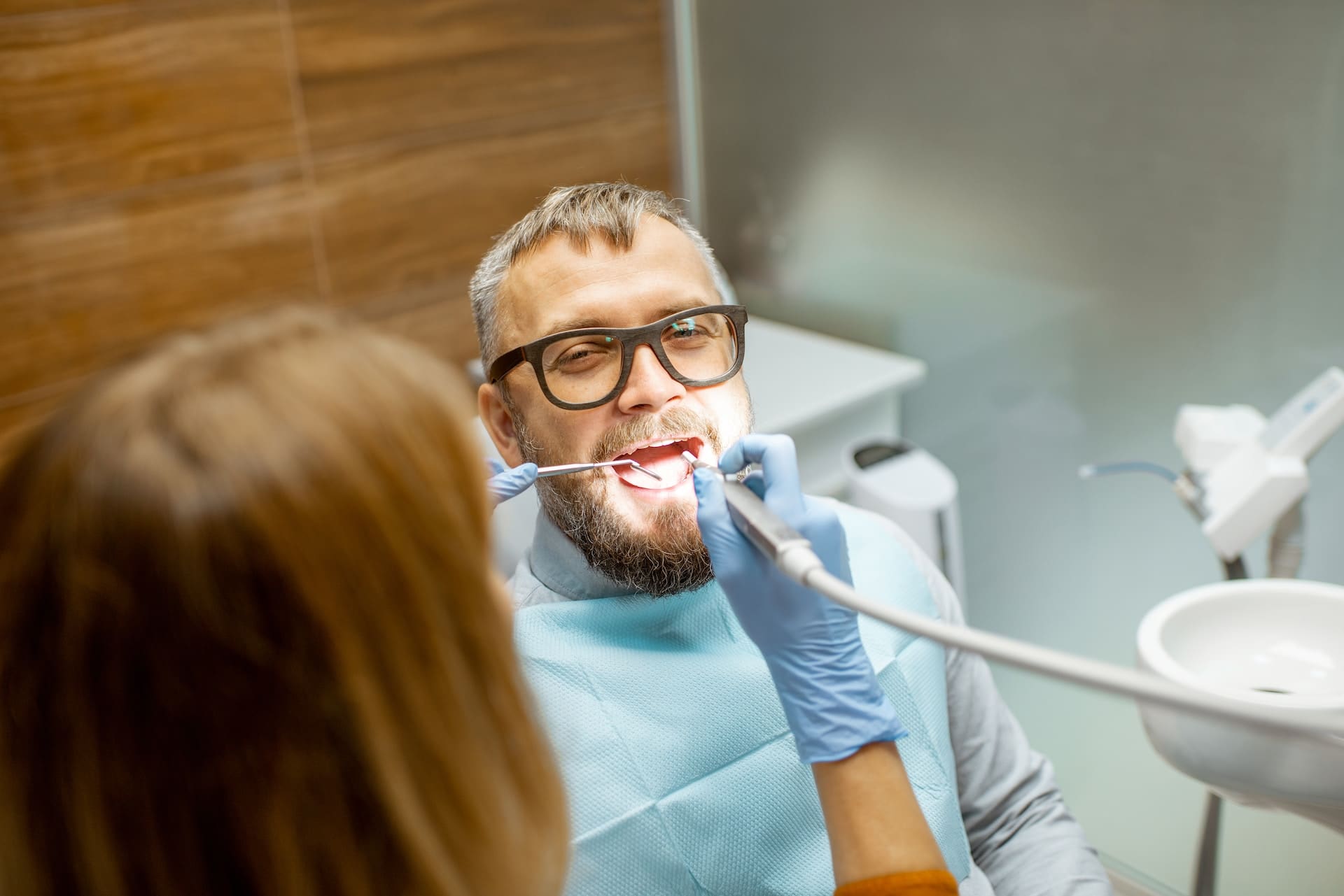 Male patient receiving dental treatment in a dental emergency