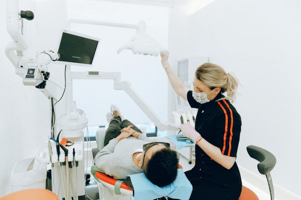 Dentist examining a patients mouth before tooth extractions in Danvers