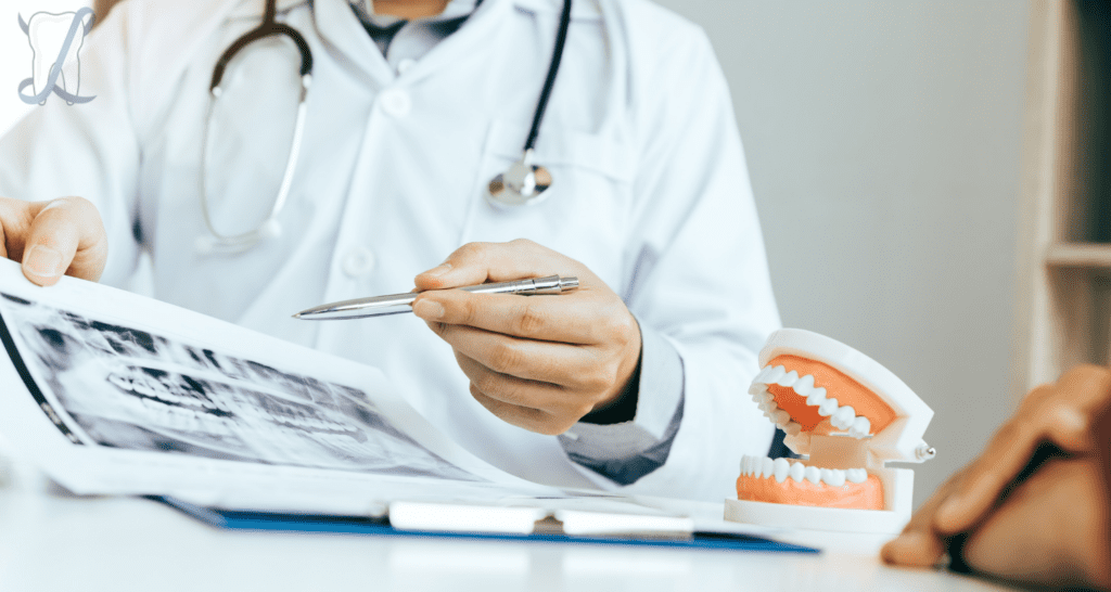 Dentist sitting across desk from patient and showing them x rays of their teeth