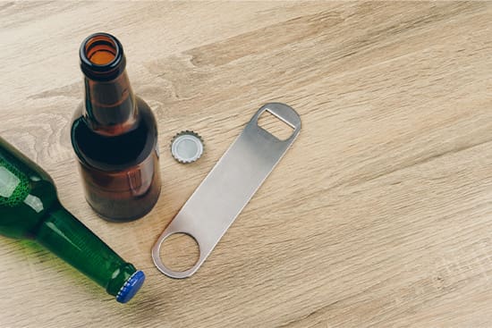 Patient in Danvers using a bottle opener