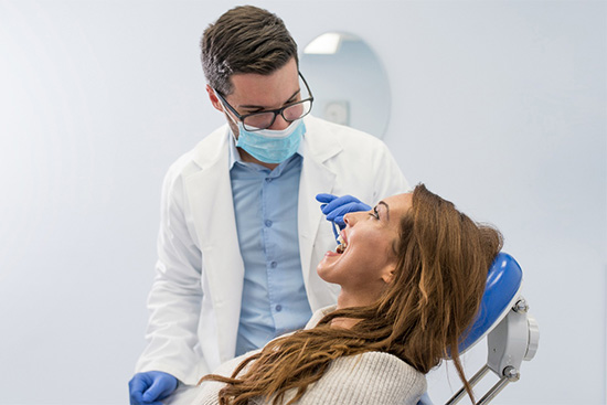 A dentist checking his patient’s smile.