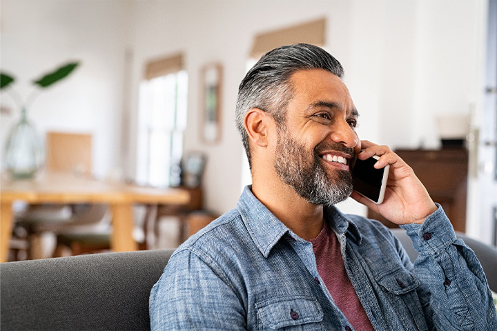 Man on the phone and smiling.
