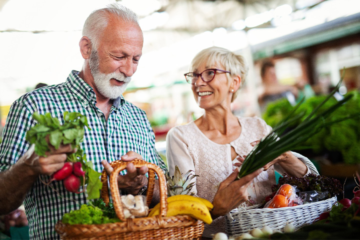 Older couple with dentures at the farmer’s market.