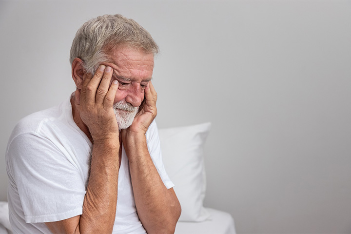 Older man unhappy with his smile.
