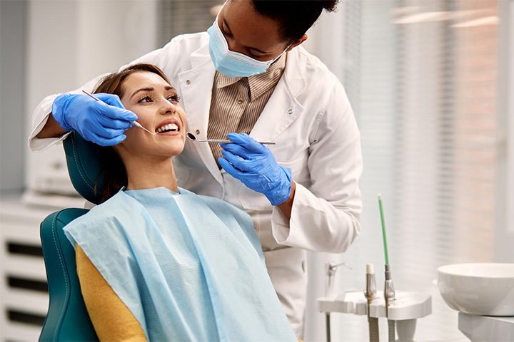 A smiling woman preparing to receive gum disease treatment.