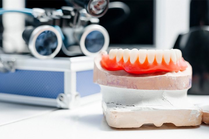The creation of a lower full denture.